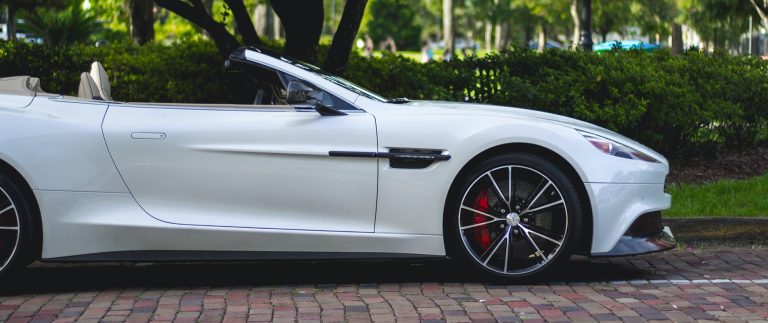 convertible parked near trees